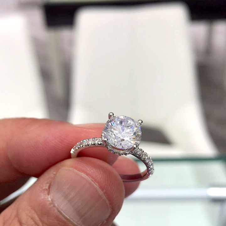 18kt White Gold Engagement Ring with 1.8 carat lab diamond at the center (Color: E | Clarity: VS1 | Round Cut) and natural E / VVS grade Setting Diamonds. Hidden halo pave set diamonds on the shank.